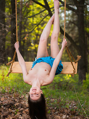 Hilary C playfully poses outdoors baring her slender body on the swing.