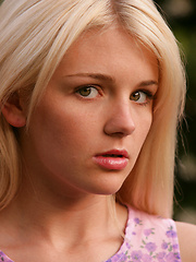 Shy white-haired girl relaxing on the backyard